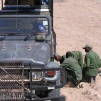 Roadside repairs as we leave the Kahahari Desert in Botswana - ExplorationVacation