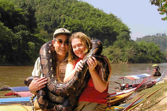 couple posing with a boa constrictor