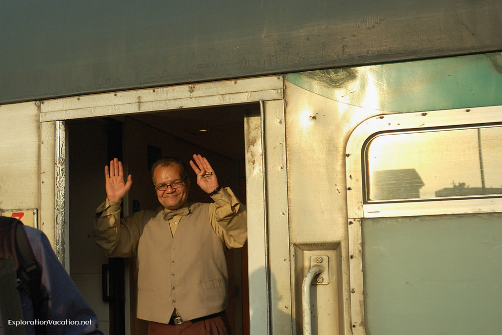 porter waiving from train in Egypt