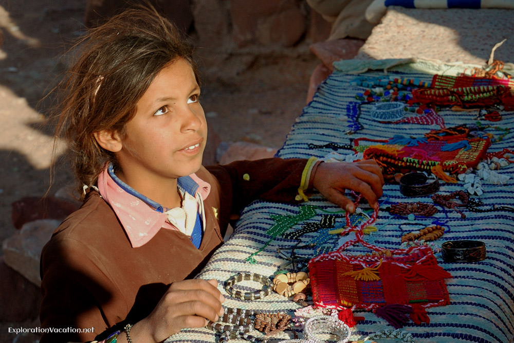 Young girl selling crafts.