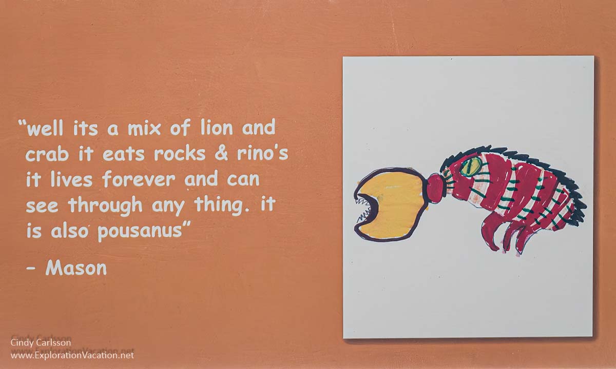 Photo of a card displaying child&rsquo;s drawing of a creature they want to see made in glass along with a description of the creature (a lioncrab) at the Museum of Glass in Tacoma, Washington in July 2023 &copy; Cindy Carlsson at ExplorationVacation.net