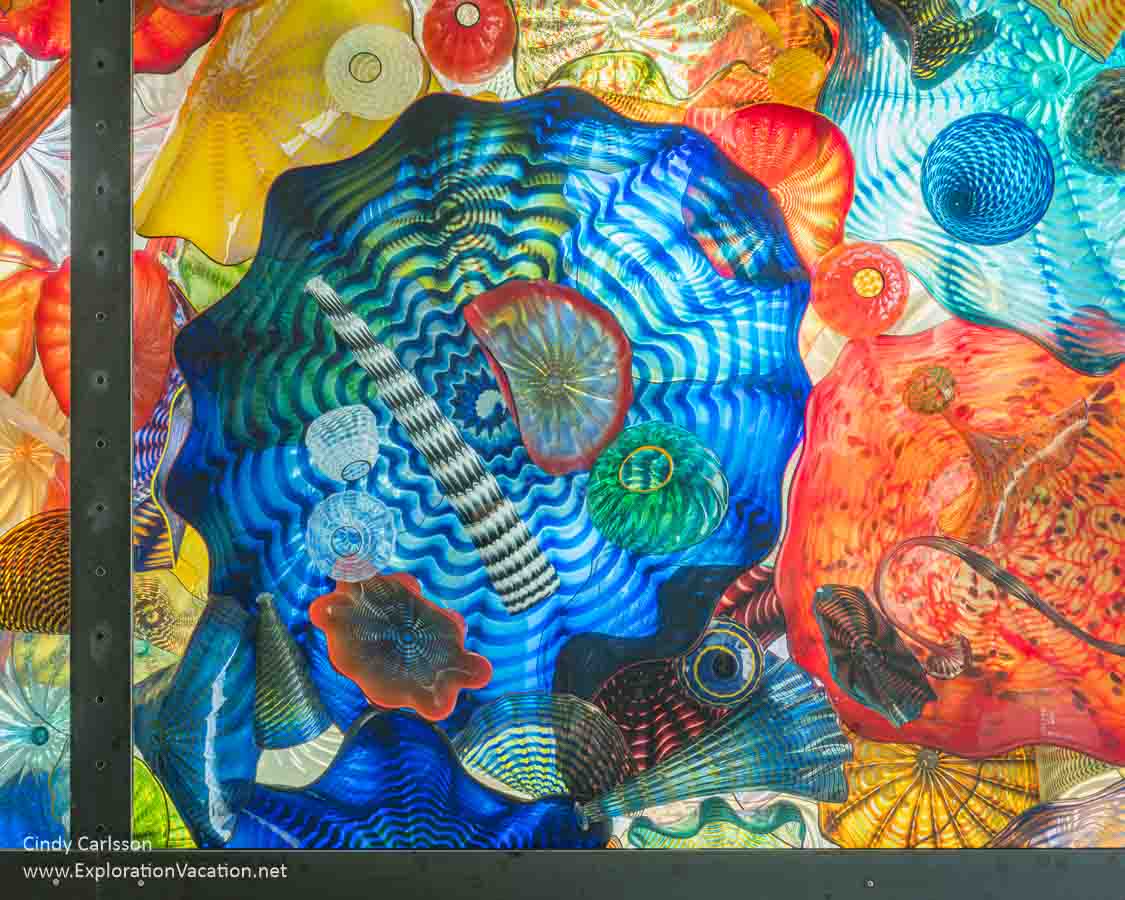 Photo looking up at the Seaform Pavilion ceiling&rsquo;s Chihuly glass forms on the Chihuly Bridge of Glass in Tacoma, Washington &copy; Cindy Carlsson at ExplorationVacation.net 