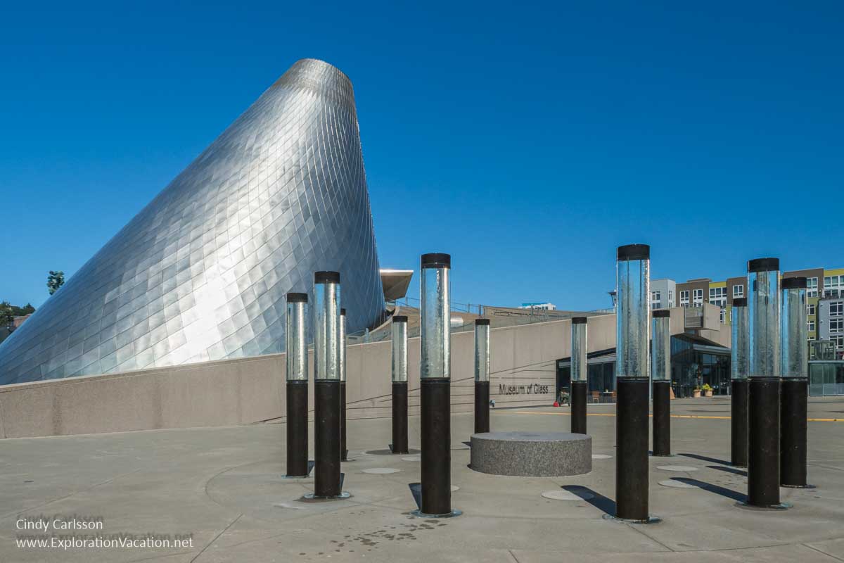 Photo of a circle of tubular fountains called &ldquo;WaterForest&rdquo; by Howard Ben Tr&eacute;, with Tacoma&rsquo;s Museum of Glass in the background &copy; Cindy Carlsson at ExplorationVacation.net