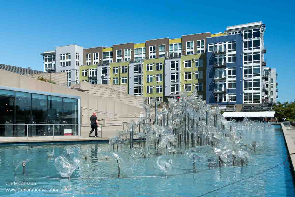 Photo of &ldquo;Fluent Steps&rdquo; by Martin Blank with the Museum of Glass on one site and a modern residential building in the background &copy; Cindy Carlsson at ExplorationVacation.net