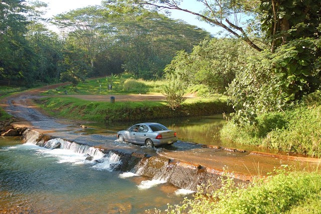 A car crossing a flooded roadway.