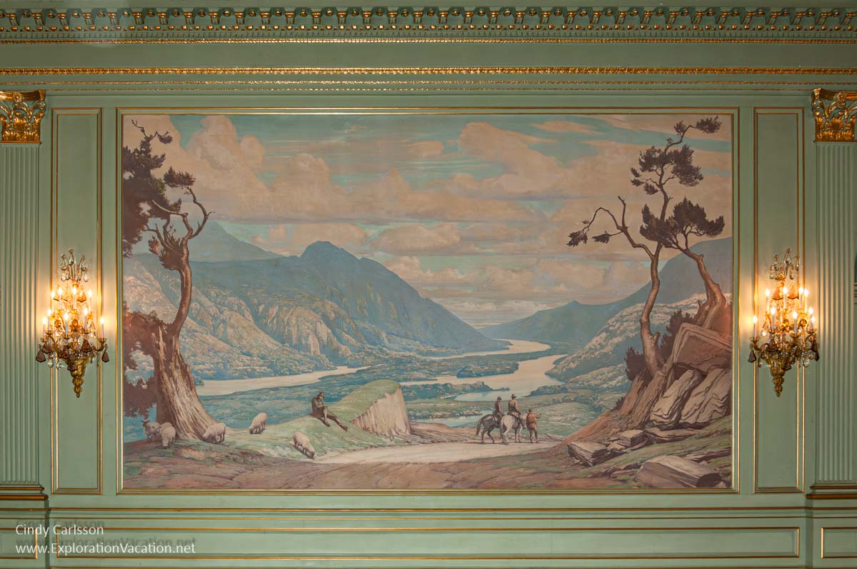 A wall mural with a scene from Ireland painted by Ernest Peixotto in the ballroom. 