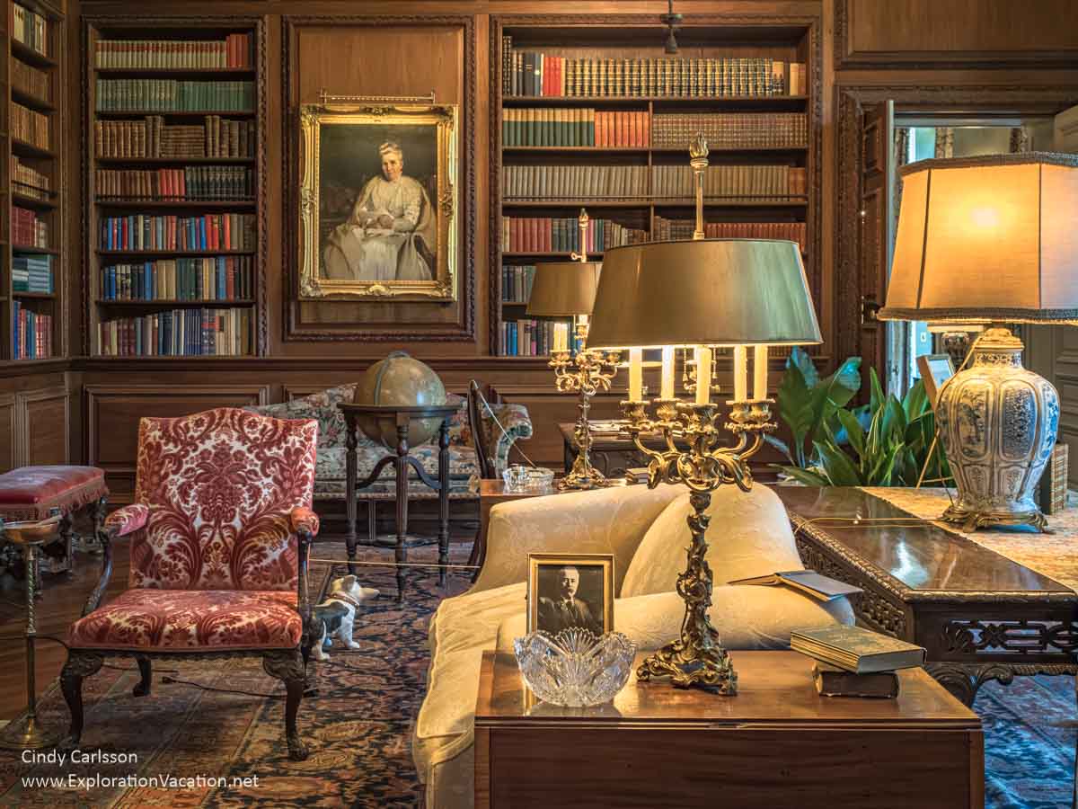 Library at Filoli House and Gardens with family paintings, seating, and walls of bookshelves.