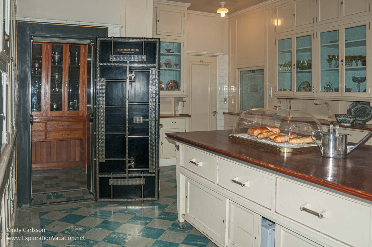 Cabinets and counters in the butler&rsquo;s pantry and silver storage beyond the open door of a walk-in vault at Filoli.