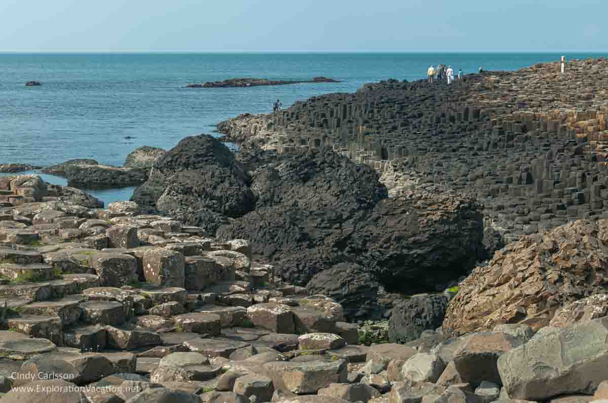 photo of people walking on the causeway at the Giant's Causeway UNESCO World Heritage site in Northern Ireland &copy; Cindy Carlsson - ExplorationVacation.net