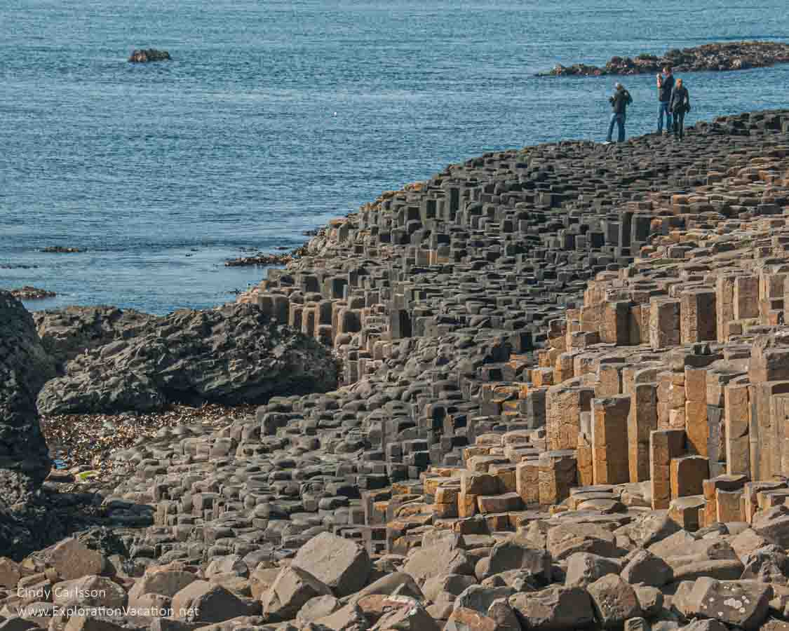 photo of people walking on the causeway at the Giant's Causeway UNESCO World Heritage site in Northern Ireland &copy; Cindy Carlsson - ExplorationVacation.net