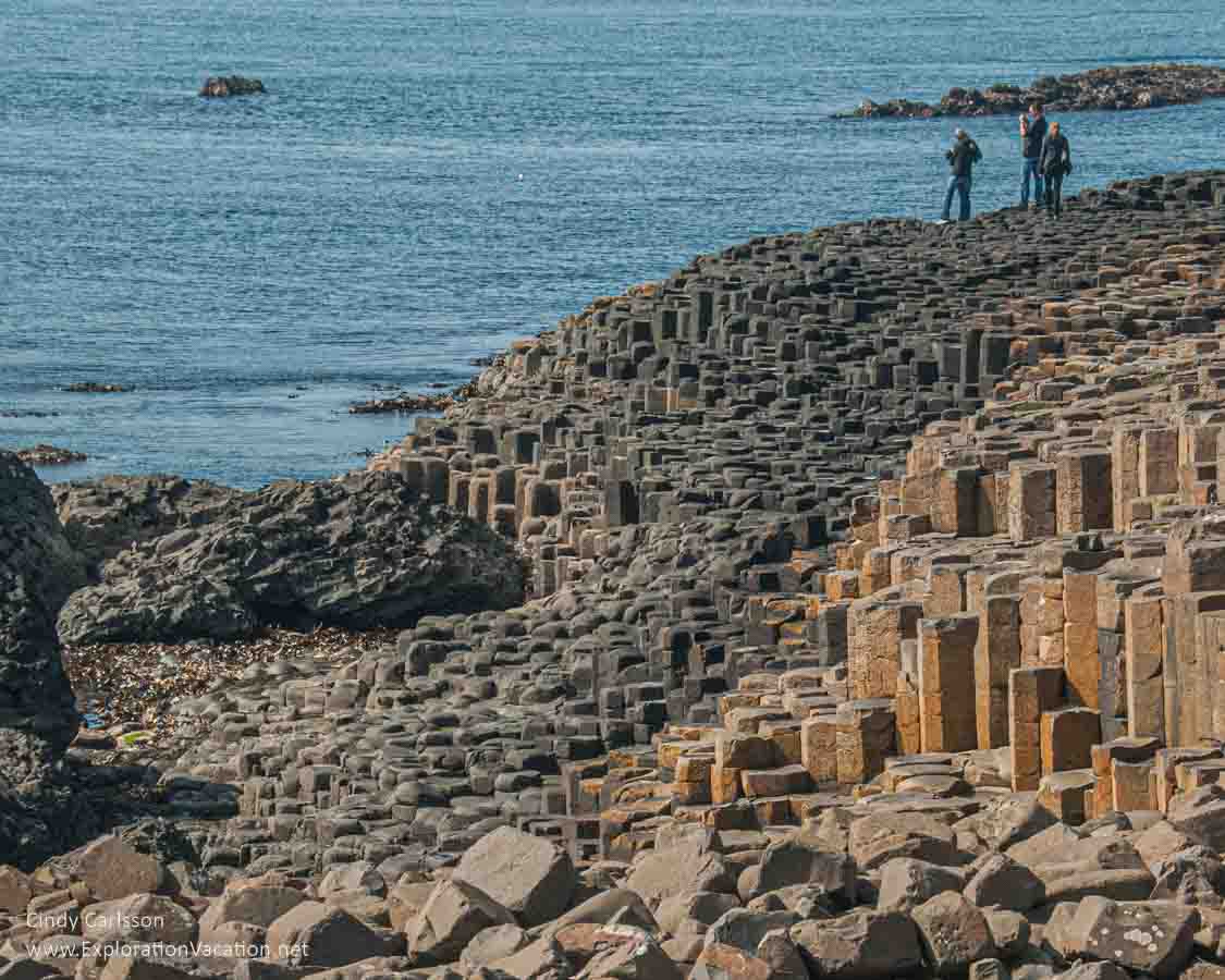 photo of people walking on the causeway at the Giant's Causeway UNESCO World Heritage site in Northern Ireland © Cindy Carlsson - ExplorationVacation.net