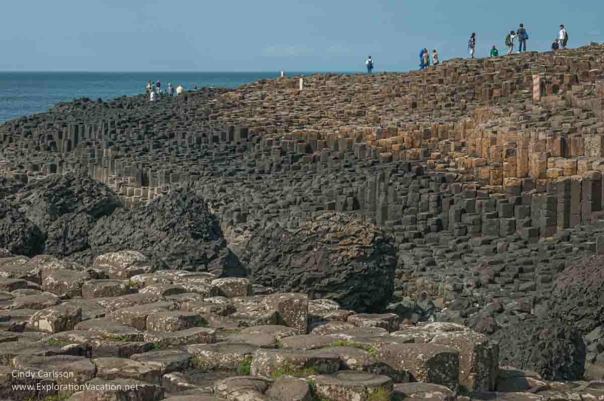 photo of people walking on the causeway at the Giant's Causeway UNESCO World Heritage site in Northern Ireland © Cindy Carlsson - ExplorationVacation.net