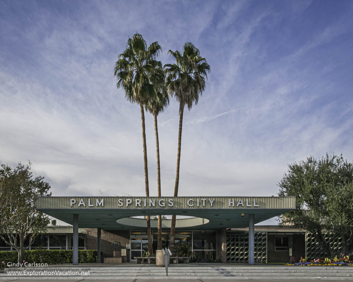 The mid-century Palm Springs City Hall, with a large circle in the entrance canopy with palm trees growing through it.