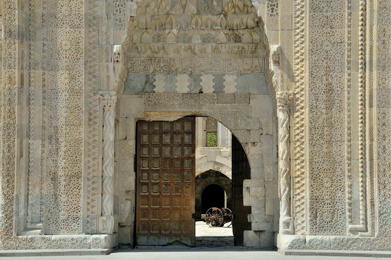 elaborately carved doorway with courtyard behind