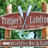 Trapper's Landing sign with canoe paddles