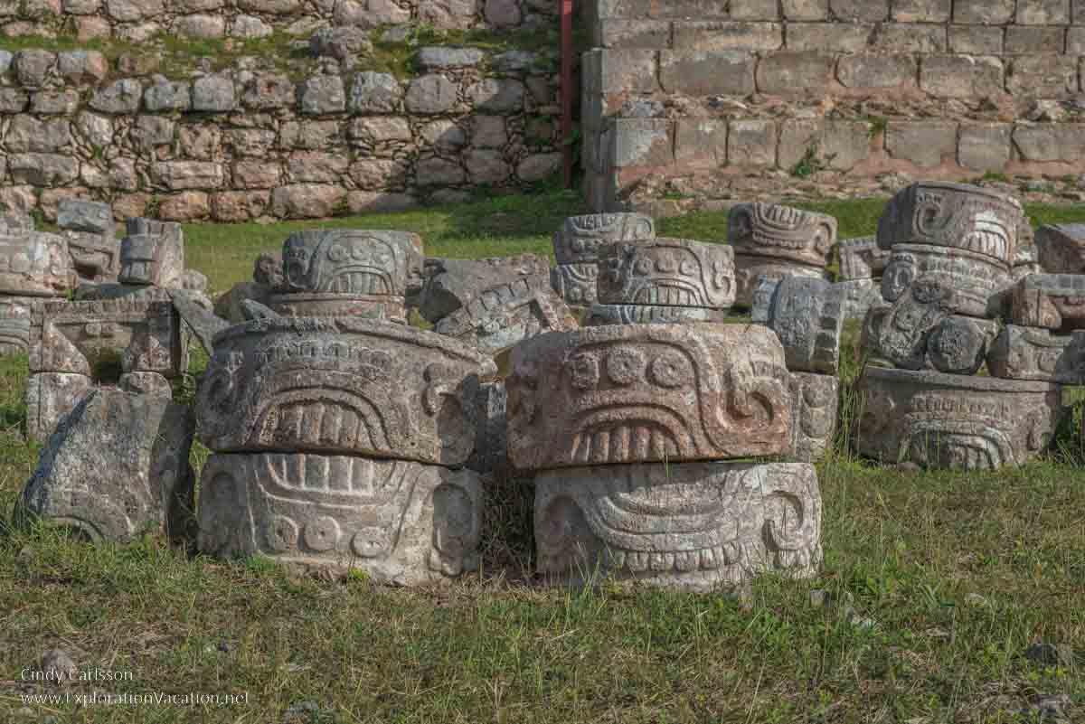 photo of carved stones that fell from the Codz Poop (Palace of the Masks) at Kabah Mexico, part of the Uxmal UNESCO World Heritage site © Cindy Carlsson at ExplorationVacation.net