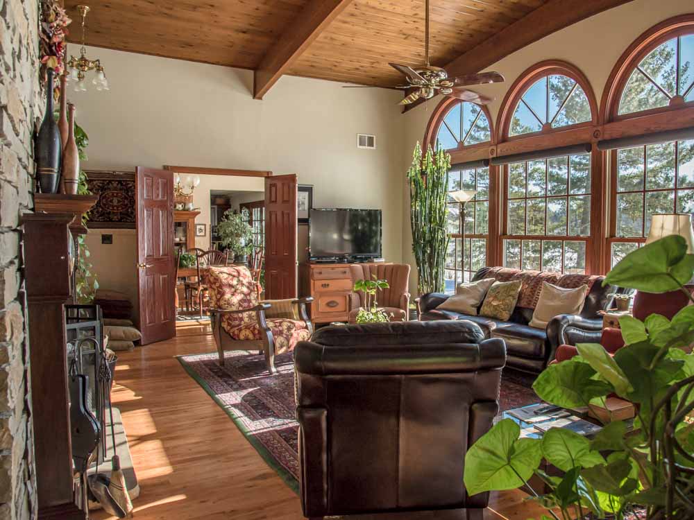 photo of living room with fireplace and big windows at Green Heron Bed and Breakfast in Grand Rapids Minnesota ©Cindy Carlsson - ExplorationVacation.net