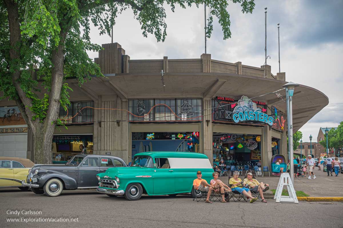 photo of people sitting and watching cars go by at the Back to the 50s weekend in St Paul Minnesota in 2016 &copy; Cindy Carlsson ExplorationVacation.net