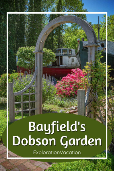 Photo of a garden gate with an old boat in the background and text: "Bayfield's Dobson Gardens - ExplorationVacation.net"