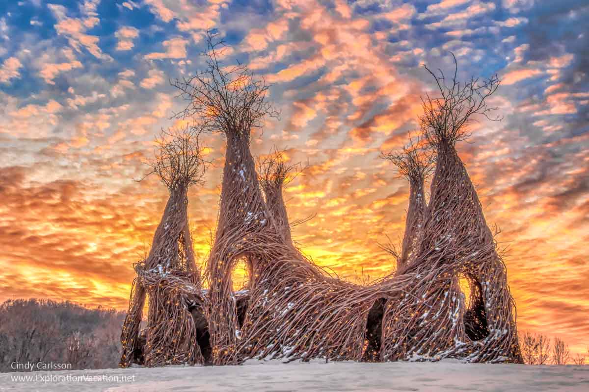 multi-towered stickwork structure at sunset 