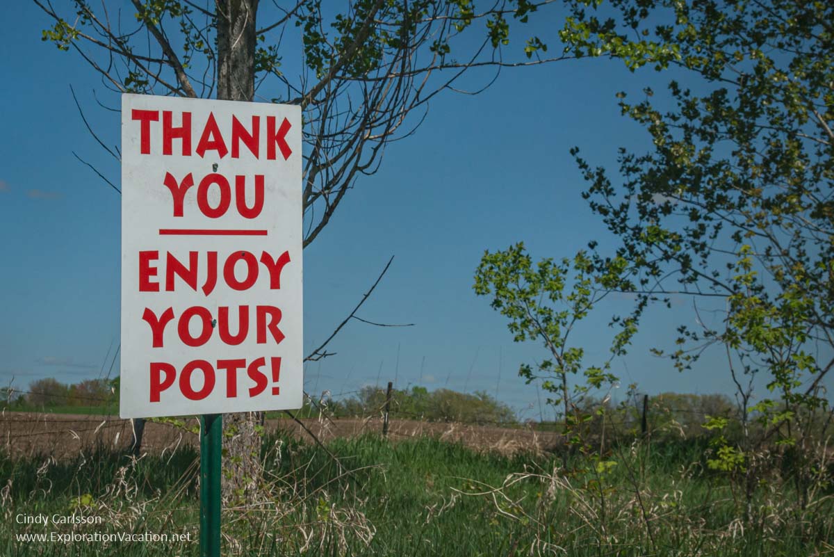 A sign that says &ldquo;Thank you &ndash; Enjoy your pots&rdquo; along a rural road in spring.