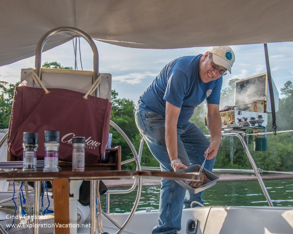 man grilling on a sailboat