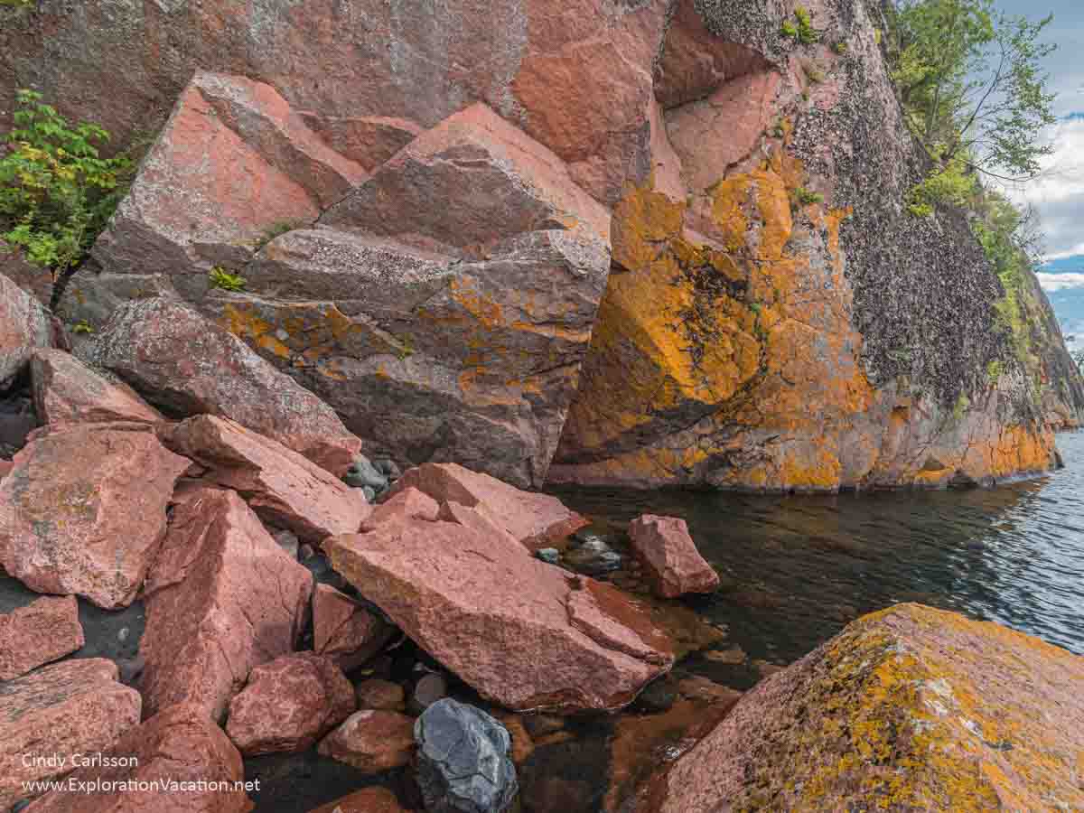 Photo of colorful stone at the base of a rock formation at Black Beach in Silver Bay, Minnesota © Cindy Carlsson at ExplorationVacation.net