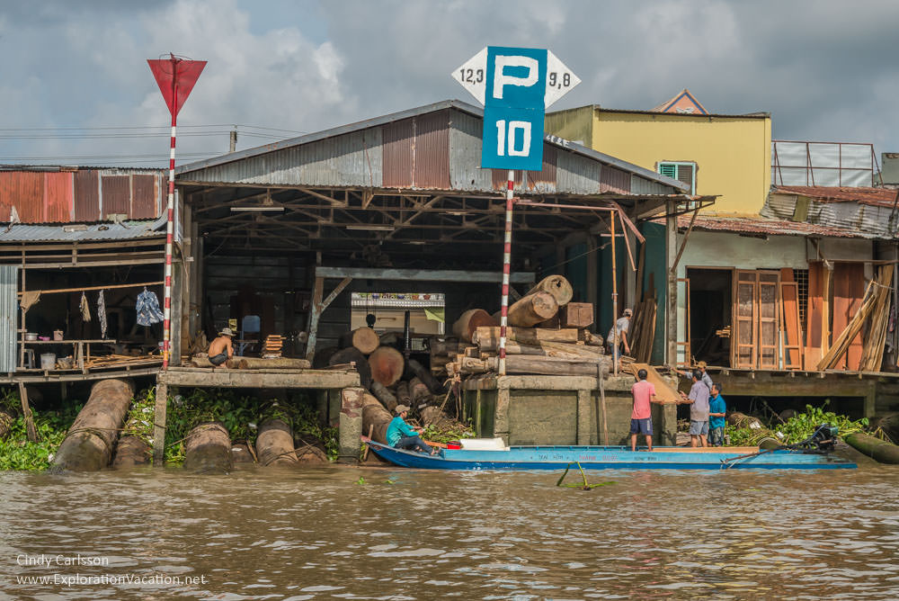 lumber yard along the water in the Mekong Delta 