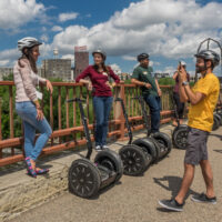 Crossing the Stone Arch Bridge (with time for photos) on a Segway tour of the historic Mill District in Minneapolis, Minnesota - ExplorationVacation