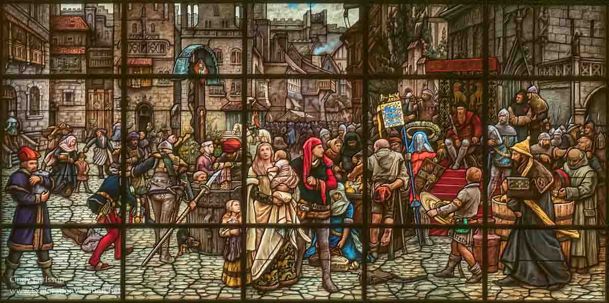 painted glass window of a medieval scene