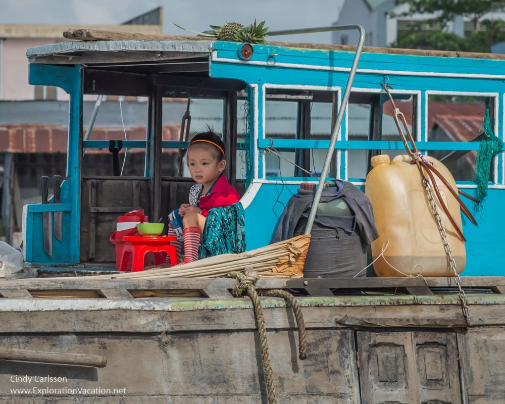 child Cai Rang floating market Vietnam - ExplorationVacation.net