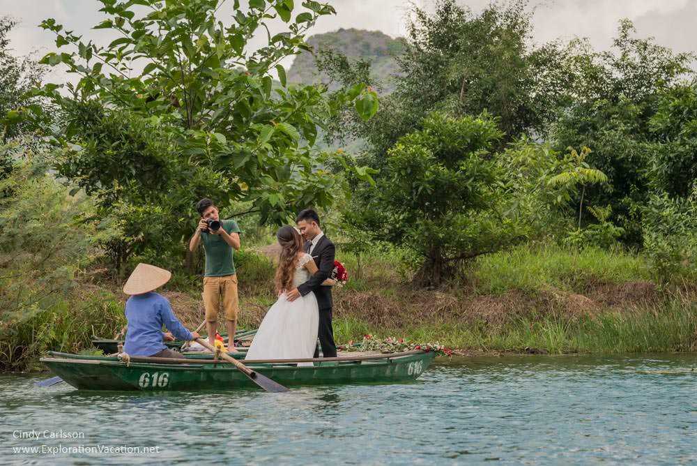 photo of photographer taking wedding pictures in Trang An Vietnam - www.ExplorationVacation.net