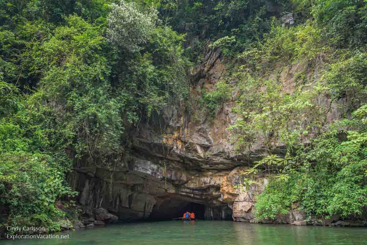 photo of a rowboat entering a cave in Trang An Vietnam - ExplorationVacation.net
