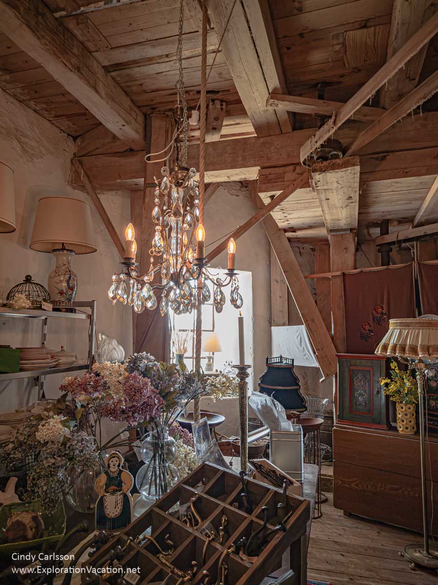 Antiques for sale below the windmill's mechanical workings.