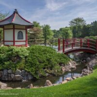 red and white building and bridge in the Japanese garden