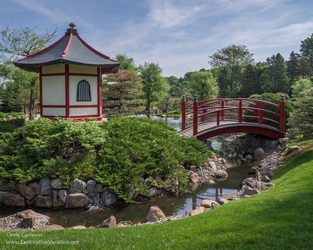 red and white building and bridge in the Japanese garden