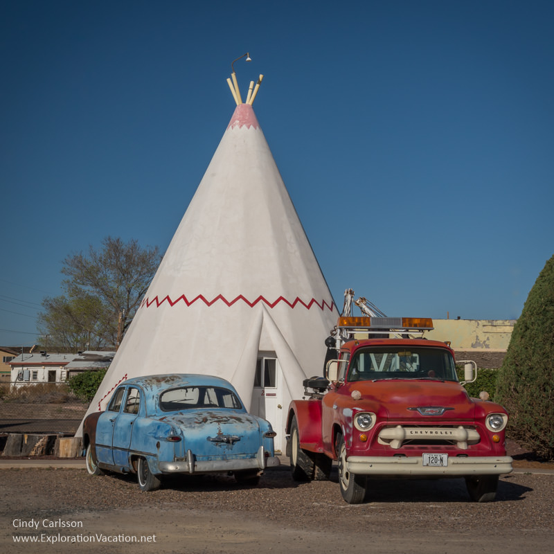 Antique cars in front of a fake tee pee