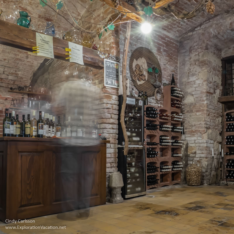 blurred figures inside the wine cellar