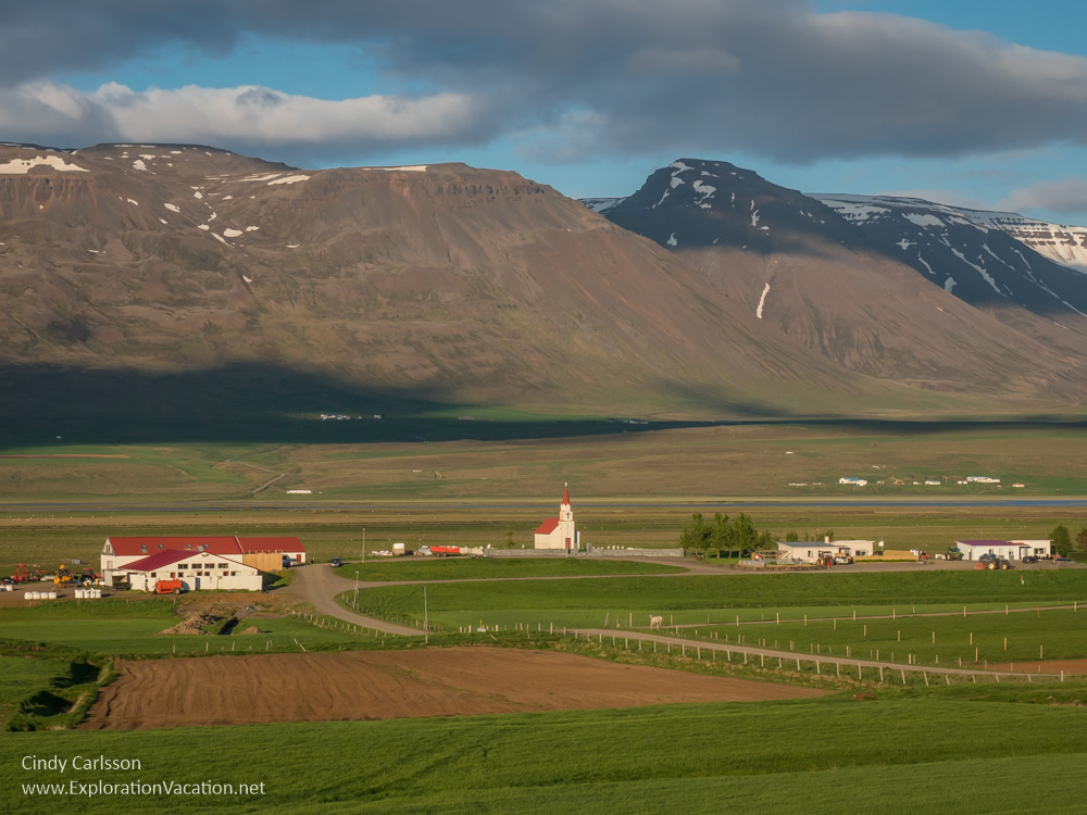 farmsteads and church below the mountains