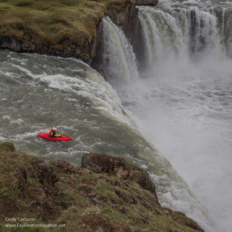 Kayaker heading over the edge of a massive waterfall.