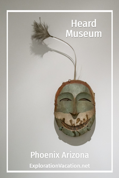carved wooden mask with text