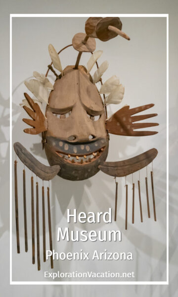 elaborate carved mask with text