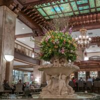 carved fountain with huge flower bouquet in a large open lobby