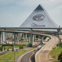 large glass pyramid towering above freeway entrance