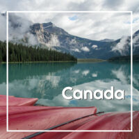 Text "Canada" with a mountain lake and boats