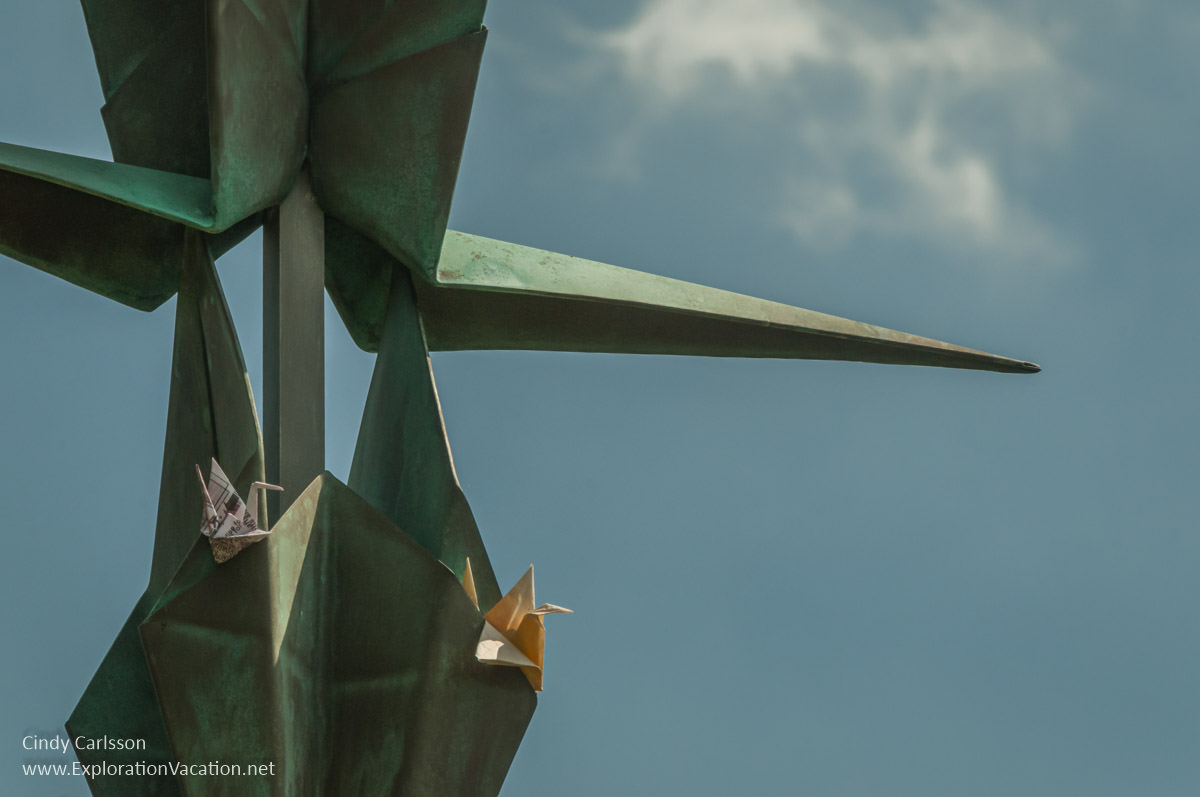 detail of sculpture with folded paper cranes tucked into it