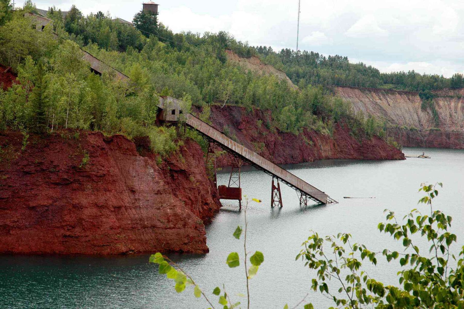 View of mine pit with water and conveyor system.