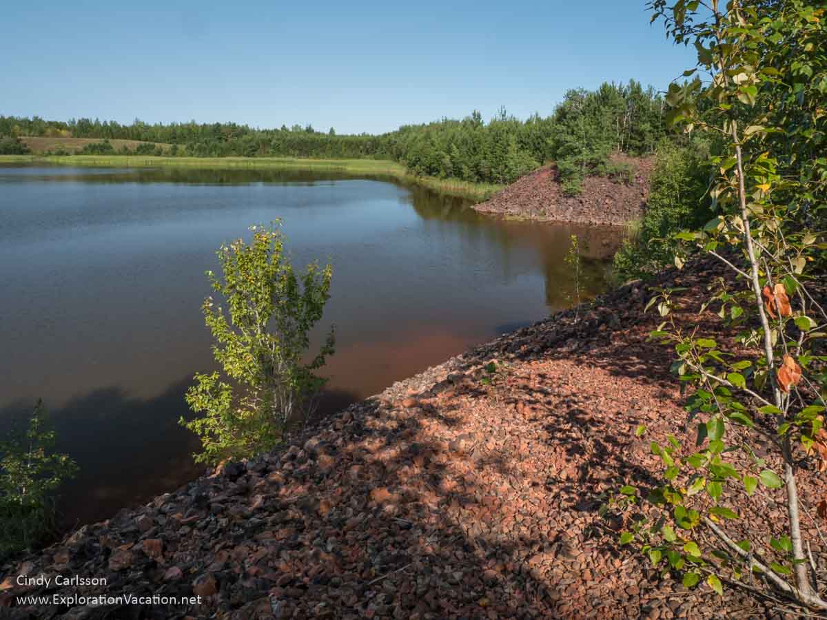 iron ore tailings piles above a lake