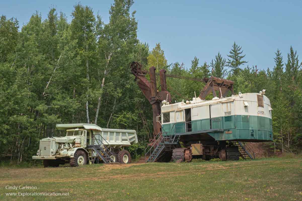 large white dump truck with a very large electric shovel