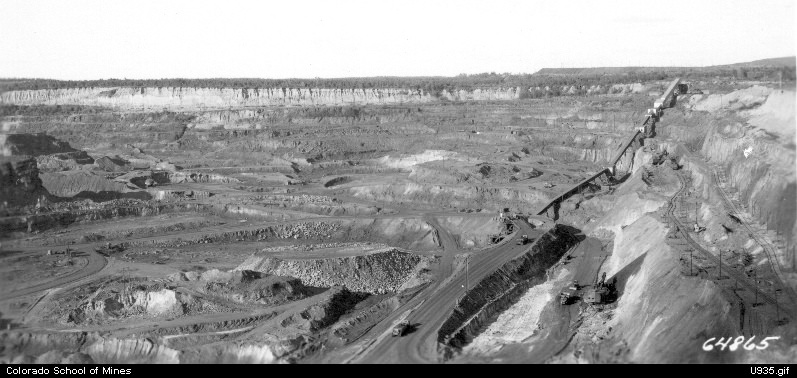 vintage black and white photograph of an open pit iron mine